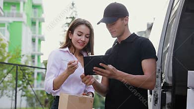 Delivery Courier Service. Man Delivering Package To Woman