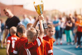 Kids Winning Sports Competition. Children Soccer Team with Trophy. Boys Celebrating Football Championship in Primary School