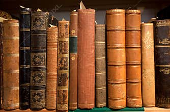 Vintage bookshelf with many books in leather covers, printed at 19th century and before. Knowledge background