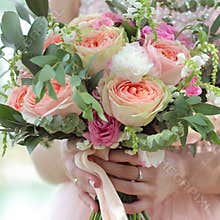 Beautiful bridal bouquet in hands of the bride. Wedding bouquet of peach roses by David Austin, single-head pink rose aqua,
