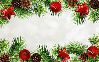 Christmas tree twigs, cones, balls and bokeh background