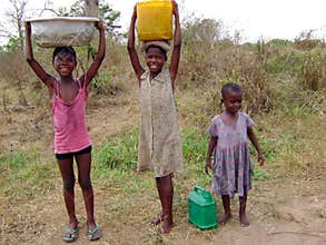 African girls taking water - Ghana