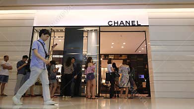 Queue People in front of Chanel Clothing Brand Luxury Fashion Shop in Siam Paragon. 4K. Bangkok, Thailand - 12 NOV 2017.