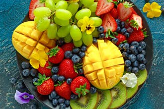 Colorful Mixed Fruit platter with Mango, Strawberry, Blueberry, Kiwi and Green Grape. Healthy food