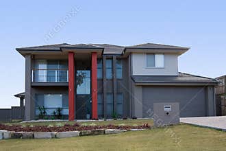 Modern grey house with red pillars