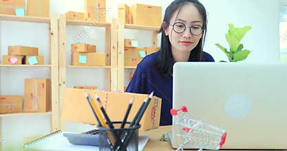 Asian woman working at home, young business start up with online business or sme concept.