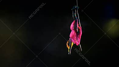 Air gymnast on canvases in circus