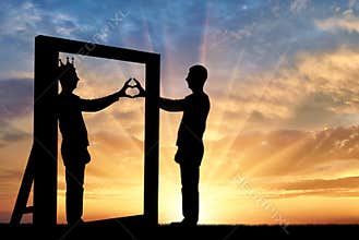 Silhouette of a narcissist man and hand gesture of a heart in reflection in the mirror and crown on his head