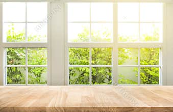 Top of wood table counter on blur window view garden background.