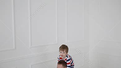 Modern healthy family. Dad and his young son go in for sports at home.