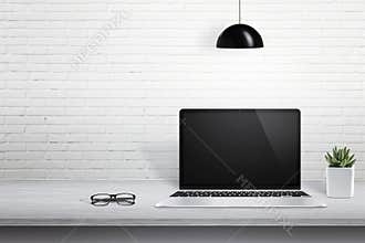 Modern laptop computer on desk with blank screen for mockup