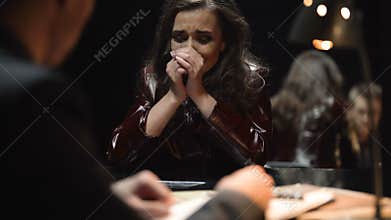 Detective showing photo to victim relative after terrorism act, woman crying