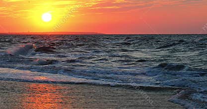 Beautifully rolling waves in the sunset rays of the sun