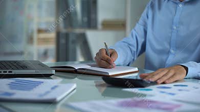 Company manager counting calculator and writing notebook, sales report, project