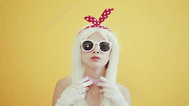 Blond girl with glasses in the image of anime doll