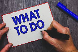 Writing note showing What To Do. Business photo showcasing asking someone advice about next action is going to be made Man holding