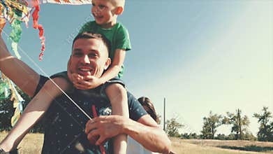 Happy family, mom, dad and son are walking in nature, launching an air snake. Stock footage.