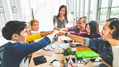 Multiethnic diverse group of office coworker, business partner fist bump in modern office. Colleague partnership teamwork concept