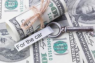 Money and business idea, The dollar bills tied with a rope, with a sign on key fob - For the car.
