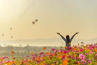 Lifestyle traveler women raise hand feeling good relax and happy freedom and see the fire balloon