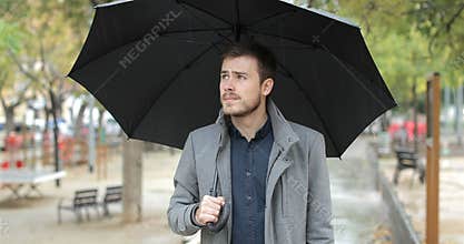 Frustrated man complaining about bad weather