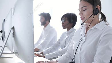 Call Center Agents Consulting Clients On Hotline At Office