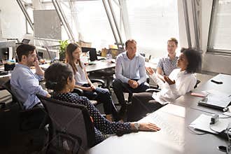 African female team leader speaking to team workers at meeting