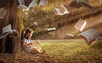 Cheerful child reading an interesting book