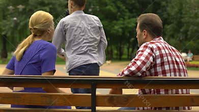 Male teen arguing with parents on bench and walking away, adolescence problems