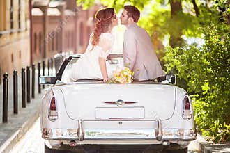 Wedding couple with old car