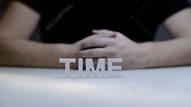 Male hands composition and breaking word time by white letter on gray background