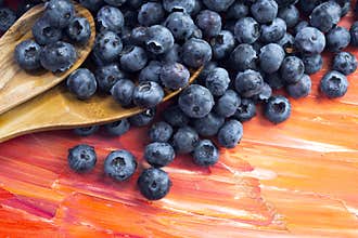 Fresh healthy berries of blueberries with wooden spoons