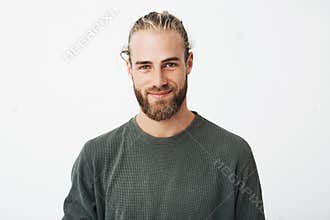 Portrait of beautiful mature blonde bearded guy with trendy hairdo in casual grey shirt smiling and looking in camera.