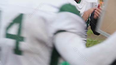 Football players applauding to support teammates entering or leaving field