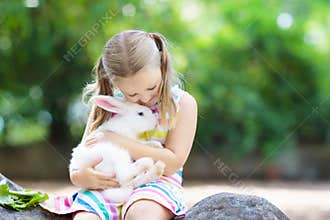 Child with rabbit. Easter bunny. Kids and pets.