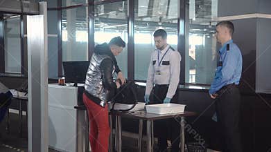 Guard checking passenger bag in airport