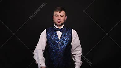 The magician shows a trick with a stick