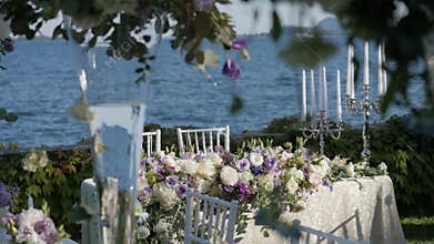 Beautiful table setting with crockery and flowers for a party, wedding reception or other festive event. On the shores