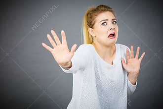 Scared woman gesturing stop gesture with hands