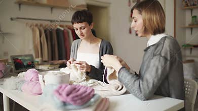 Two knitting woman working in textile workshop. Woman hobby knitting hands