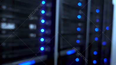 Data center, server room in a blurry background. Blinking blue led ligts