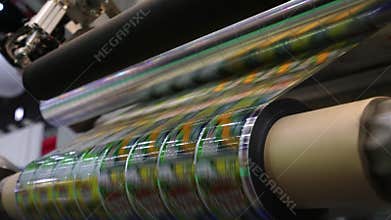 High speed labeling machine in industrial factory. Machine for sticker on product in manufacture. Flexible packaging