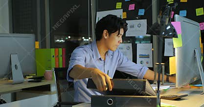 Overworked businessman working late at night in the office.