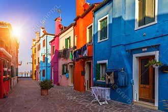 Lovely house facade and colorful walls in Burano, Venice. Burano island canal, colorful houses and boats, Venice landmark, Italy.