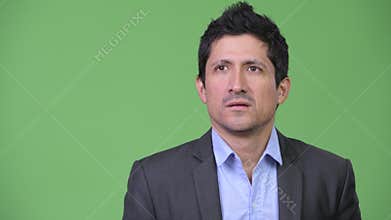 Hispanic businessman looking bored while thinking