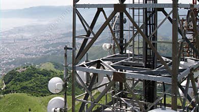 Aerial view of telecommunications towers antennas and cityscape in the background
