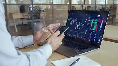 Crypto trader broker using phone app analyzing stock market on cell phone.