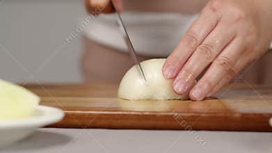 cook cuts onion into large pieces knife