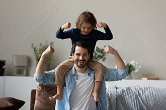 Little son sit on fathers shoulder demonstrate bicep strength