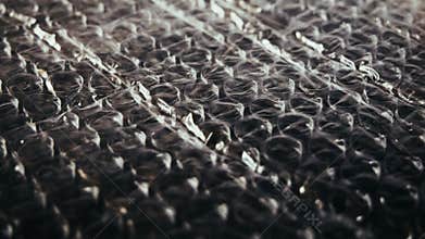 Bubble wrap is a pliable transparent plastic material used for packing fragile items. Regularly spaced, protruding air-filled